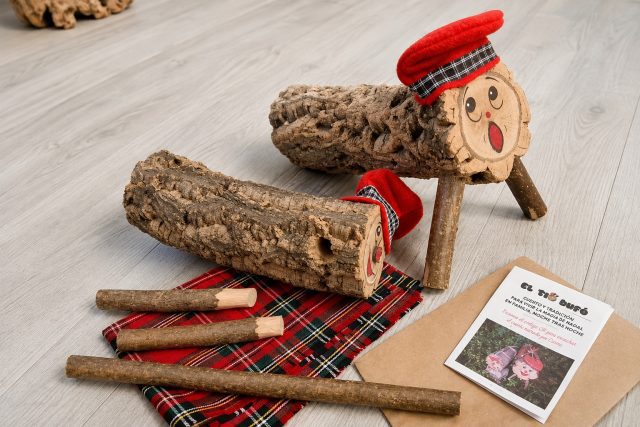 Un Tió Bufó i una Tiona esperen davant la porta de casa perquè els nens els descobreixin i comenci la màgia del Tió de Nadal.